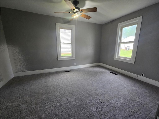 117 E Buford St, Wellington, MO 64097 - empty room featuring plenty of natural light, ceiling fan, and carpet floors