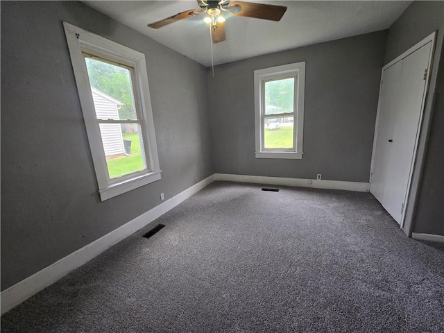 117 E Buford St, Wellington, MO 64097 - carpeted spare room featuring healthy amount of natural light, a ceiling fan, and baseboards
