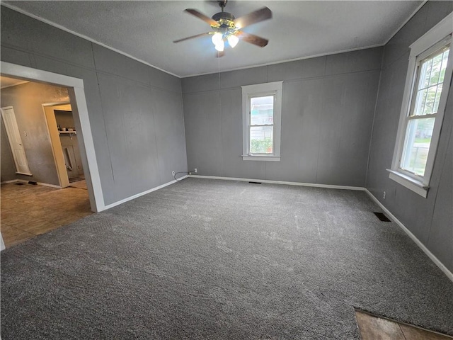 117 E Buford St, Wellington, MO 64097 - spare room with ceiling fan, carpet floors, and baseboards