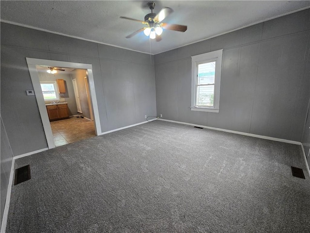 117 E Buford St, Wellington, MO 64097 - carpeted empty room featuring a ceiling fan and baseboards