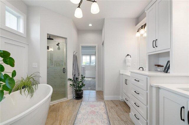 2705 NE Crestview St, Blue Springs, MO 64029 - full bathroom featuring a shower stall, plenty of natural light, vanity, a freestanding tub, and recessed lighting