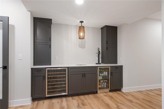 2705 NE Crestview St, Blue Springs, MO 64029 - indoor bar featuring beverage cooler, baseboards, and light wood finished floors