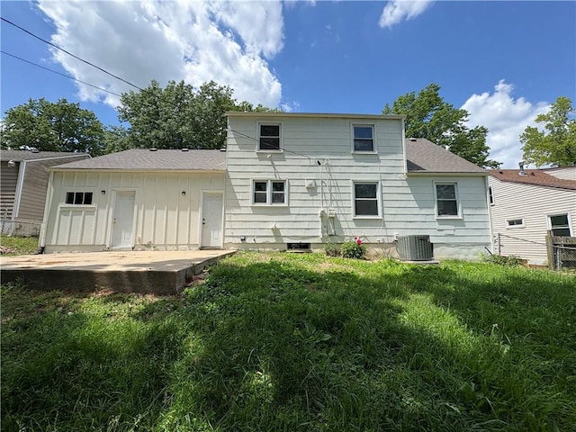 7115 Myrtle Ave, Kansas City, MO 64132 - back of house with central air condition unit, a patio, roof with shingles, and board and batten siding