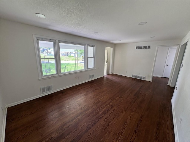 7115 Myrtle Ave, Kansas City, MO 64132 - unfurnished room with dark wood-type flooring, baseboards, and a textured ceiling