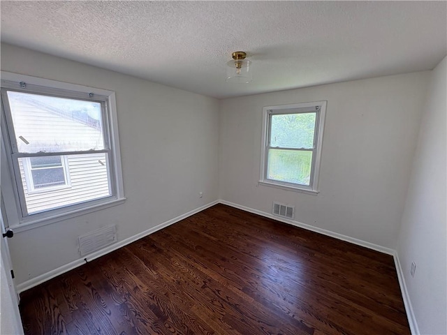7115 Myrtle Ave, Kansas City, MO 64132 - spare room with wood finished floors, baseboards, and a textured ceiling