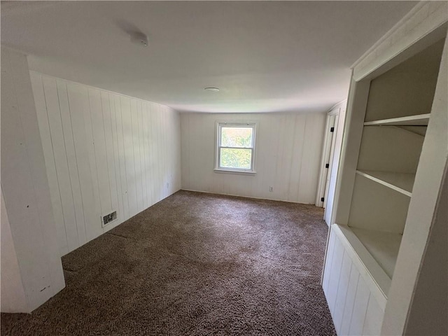 7115 Myrtle Ave, Kansas City, MO 64132 - unfurnished bedroom with carpet flooring and wood walls