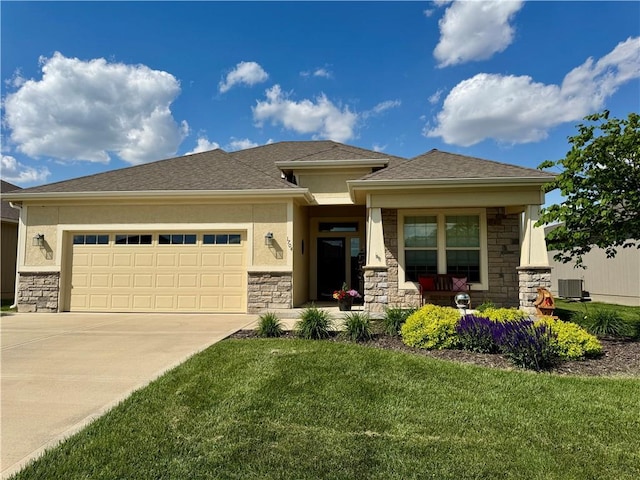 1704 W Glen Dr, Leavenworth, KS 66048 - prairie-style house featuring stone siding, an attached garage, concrete driveway, and a front lawn