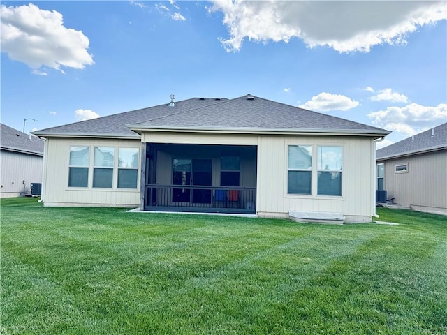 1704 W Glen Dr, Leavenworth, KS 66048 - back of property featuring a yard, a shingled roof, and a sunroom
