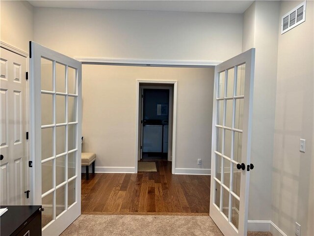 1704 W Glen Dr, Leavenworth, KS 66048 - hallway featuring french doors, wood finished floors, and baseboards