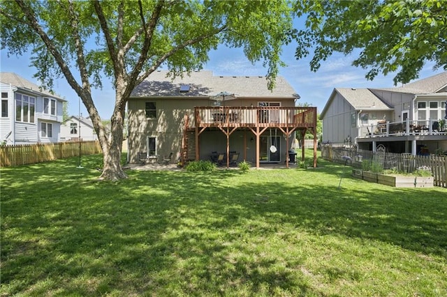 rear view of house with a deck and a vegetable garden