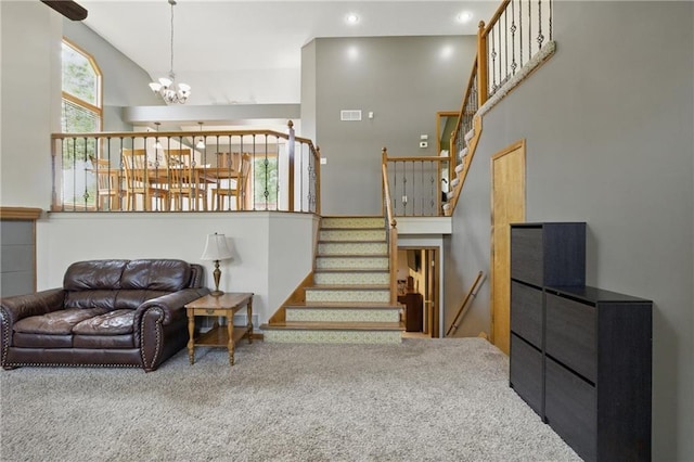 living room featuring carpet, a chandelier, stairway, a high ceiling, and recessed lighting