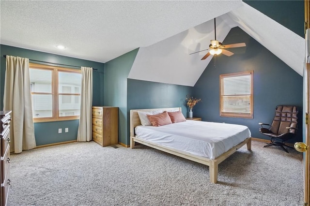 carpeted bedroom featuring lofted ceiling, a ceiling fan, a textured ceiling, and baseboards