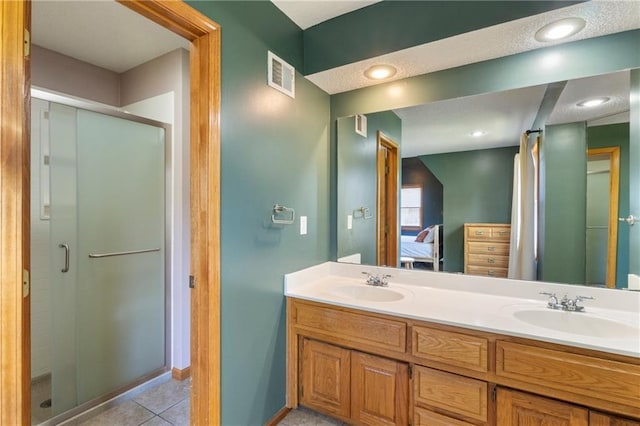 full bath featuring ensuite bath, a stall shower, double vanity, and tile patterned flooring