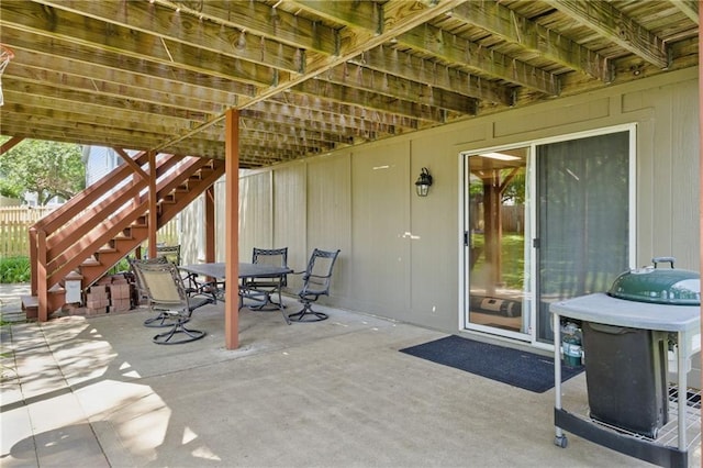 view of patio with stairs and outdoor dining space
