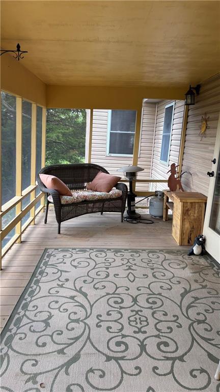 sunroom / solarium featuring hardwood / wood-style flooring