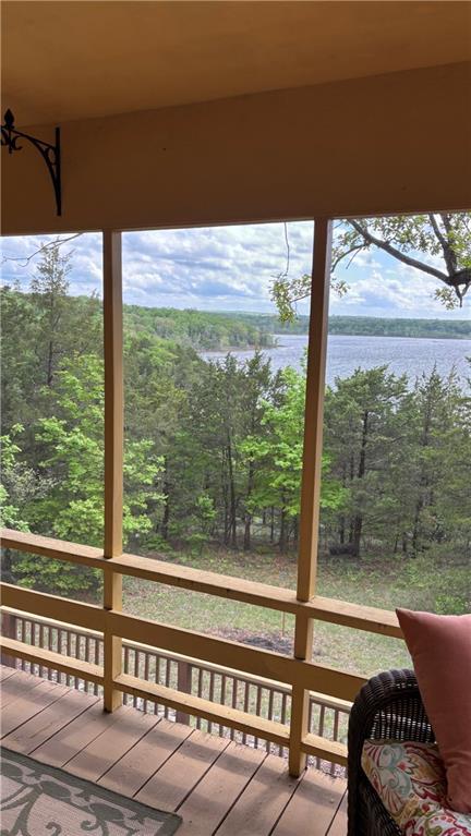 sunroom / solarium with a water view