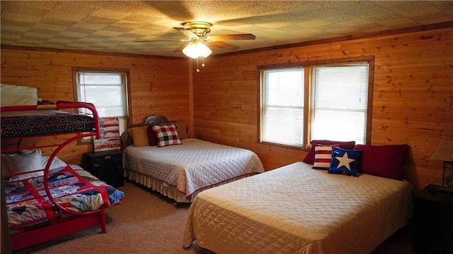 25996 Arrowhead Rd, Hermitage, MO 65668 - bedroom with wood walls, carpet floors, and ceiling fan