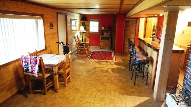 25996 Arrowhead Rd, Hermitage, MO 65668 - dining space with wood walls and light tile patterned flooring
