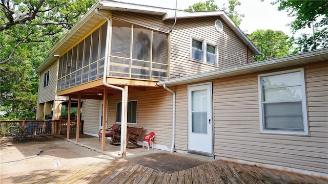 25996 Arrowhead Rd, Hermitage, MO 65668 - back of property featuring a deck and a sunroom