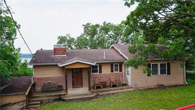 25996 Arrowhead Rd, Hermitage, MO 65668 - view of front facade featuring brick siding, a chimney, a front lawn, and a deck