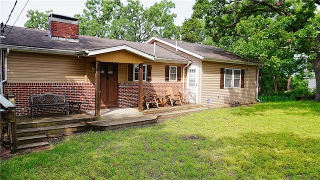 25996 Arrowhead Rd, Hermitage, MO 65668 - rear view of property featuring brick siding, a chimney, a yard, and covered porch