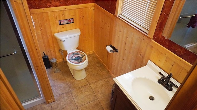 25996 Arrowhead Rd, Hermitage, MO 65668 - bathroom featuring wooden walls, toilet, a shower stall, vanity, and tile patterned floors