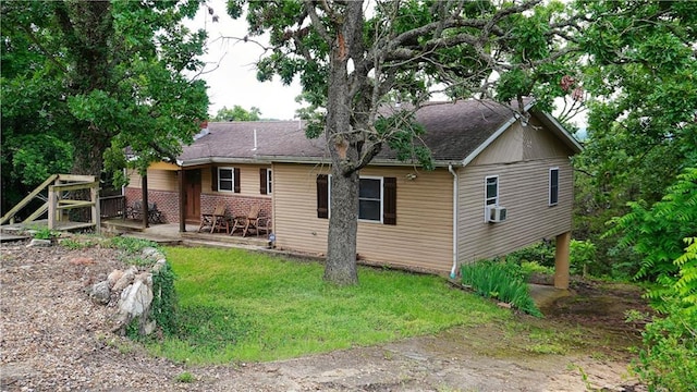 25996 Arrowhead Rd, Hermitage, MO 65668 - rear view of property featuring a yard, a patio area, a shingled roof, and cooling unit