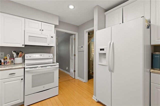 kitchen featuring white appliances, light countertops, light wood finished floors, white cabinets, and recessed lighting