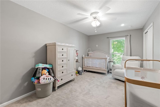 bedroom with carpet flooring, a textured ceiling, and a ceiling fan