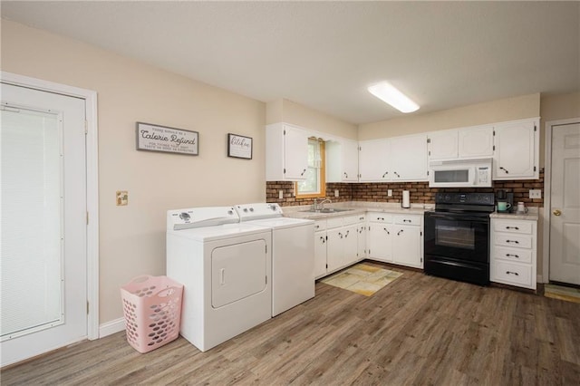 laundry room featuring washer and dryer and wood finished floors