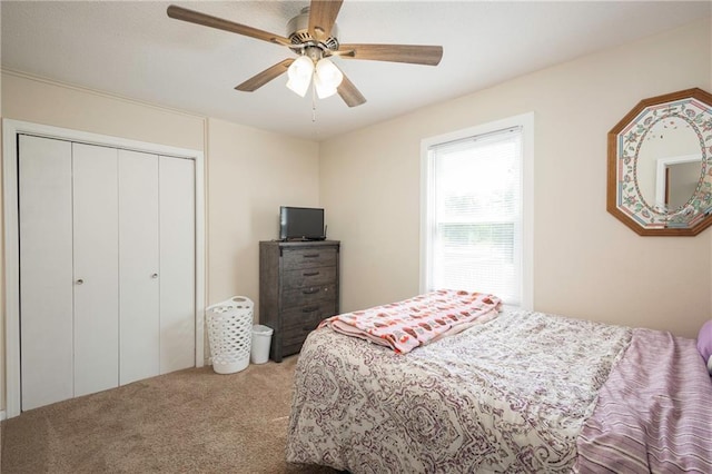bedroom with carpet flooring, a closet, and a ceiling fan