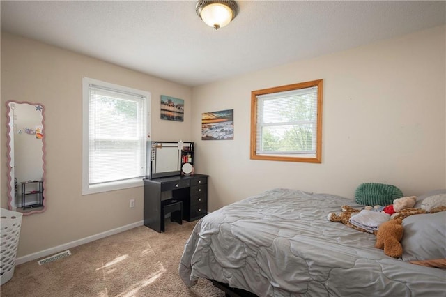 carpeted bedroom with baseboards