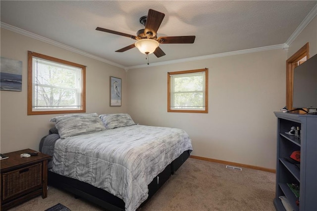 bedroom with multiple windows, ornamental molding, carpet, a ceiling fan, and baseboards