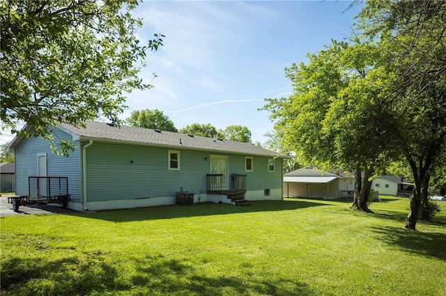 back of house with a lawn and a detached carport