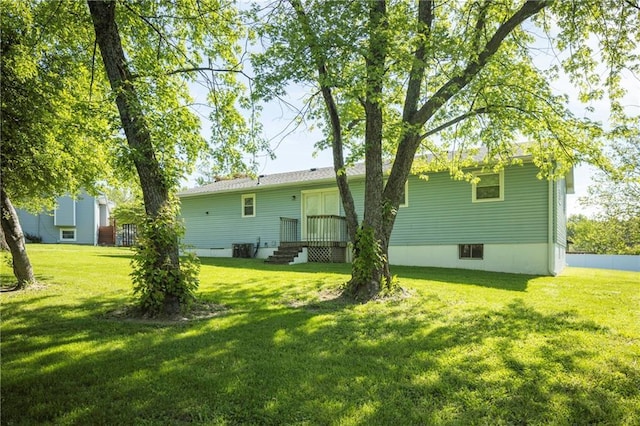 back of house with a lawn and central AC unit