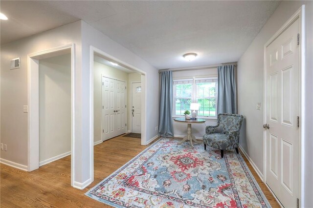 9711 Roe Ave, Overland Park, KS 66207 - sitting room with wood finished floors and baseboards