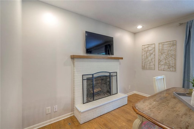 9711 Roe Ave, Overland Park, KS 66207 - living room featuring a fireplace, wood finished floors, and recessed lighting