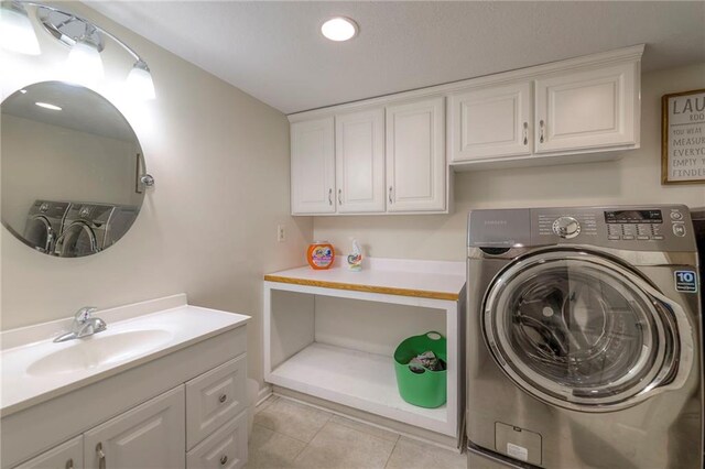 9711 Roe Ave, Overland Park, KS 66207 - laundry room with washer / dryer, light tile patterned floors, cabinet space, and recessed lighting