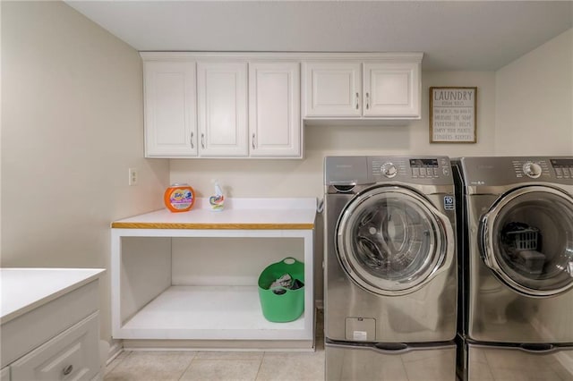 9711 Roe Ave, Overland Park, KS 66207 - laundry area with washing machine and dryer, cabinet space, and light tile patterned flooring