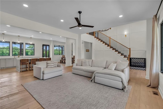 21851 179th St, Tonganoxie, KS 66086 - living area featuring light wood-style flooring, recessed lighting, stairway, and ceiling fan