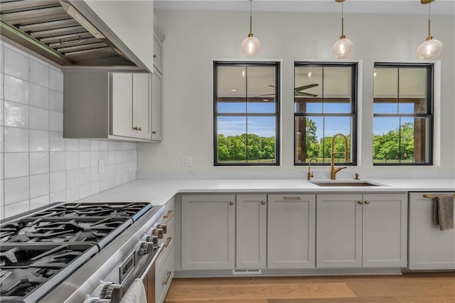 21851 179th St, Tonganoxie, KS 66086 - kitchen featuring extractor fan, high end stainless steel range, plenty of natural light, and light countertops