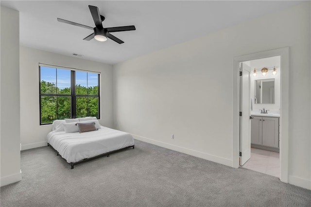 21851 179th St, Tonganoxie, KS 66086 - bedroom with light carpet, a ceiling fan, and connected bathroom