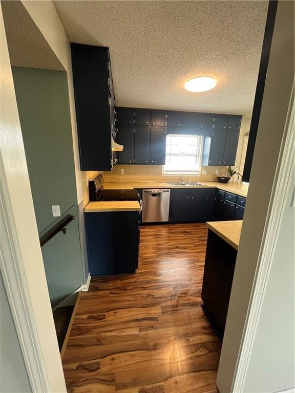 1424 S Olive St, Ottawa, KS 66067 - kitchen with dishwasher, a textured ceiling, electric range oven, dark wood-type flooring, and dark cabinetry