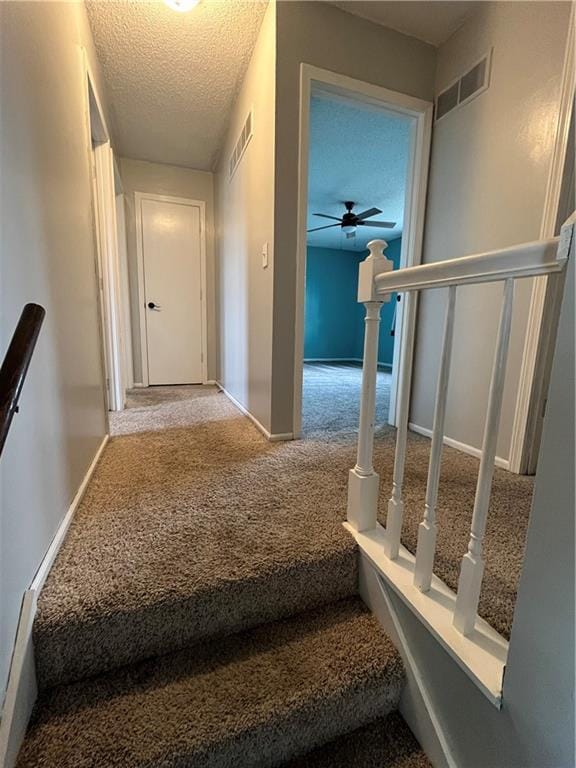 1424 S Olive St, Ottawa, KS 66067 - stairway with carpet flooring, a textured ceiling, and ceiling fan