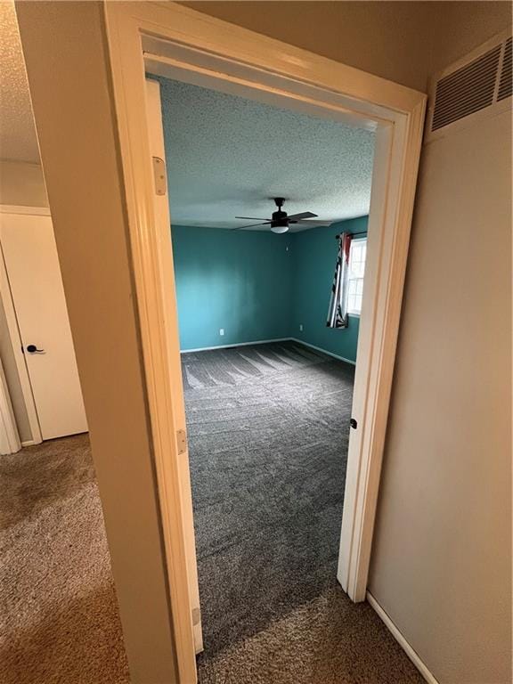 1424 S Olive St, Ottawa, KS 66067 - spare room featuring carpet floors, a ceiling fan, and a textured ceiling