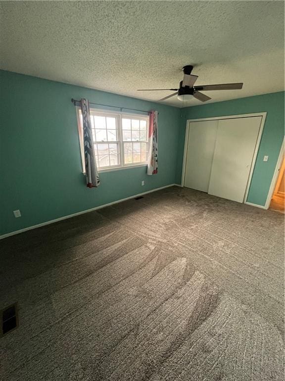 1424 S Olive St, Ottawa, KS 66067 - unfurnished bedroom with a textured ceiling, a closet, carpet floors, and a ceiling fan