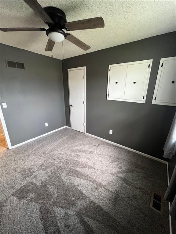 1424 S Olive St, Ottawa, KS 66067 - unfurnished bedroom with a textured ceiling, carpet, and a ceiling fan