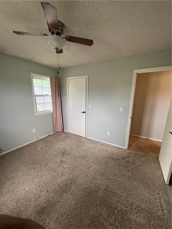 1424 S Olive St, Ottawa, KS 66067 - unfurnished bedroom with carpet, a textured ceiling, and ceiling fan