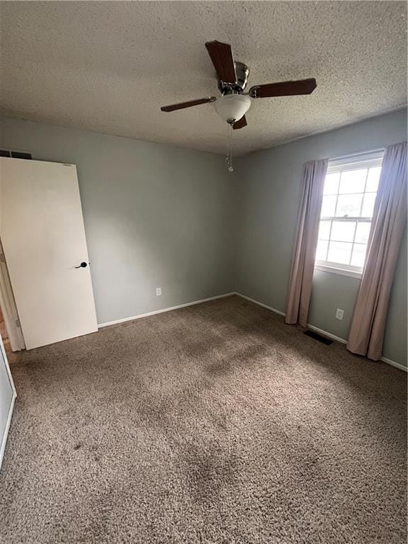 1424 S Olive St, Ottawa, KS 66067 - carpeted empty room with ceiling fan and a textured ceiling