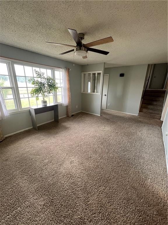 1424 S Olive St, Ottawa, KS 66067 - spare room featuring a textured ceiling, a ceiling fan, carpet, and stairs